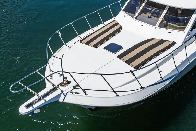 Shady Lady Yacht Photos Pics 1995 Navigator Classic yacht with striped sun pads on deck, cruising on water.