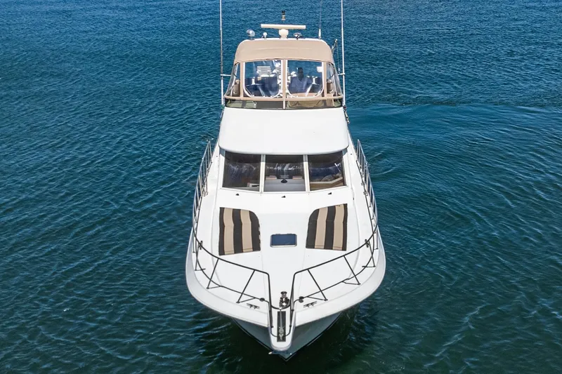 Shady Lady Yacht Photos Pics Front view of a 1995 Navigator Classic yacht on calm blue water.