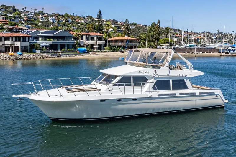 Shady Lady Yacht Photos Pics 1995 Navigator Classic yacht cruising near coastal homes and marina.