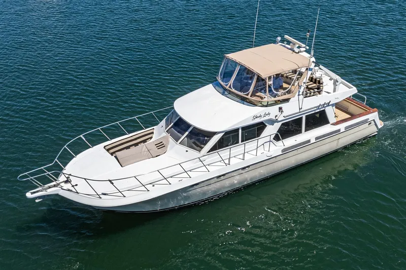 Shady Lady Yacht Photos Pics Navigator Classic 1995 yacht cruising on clear blue water.