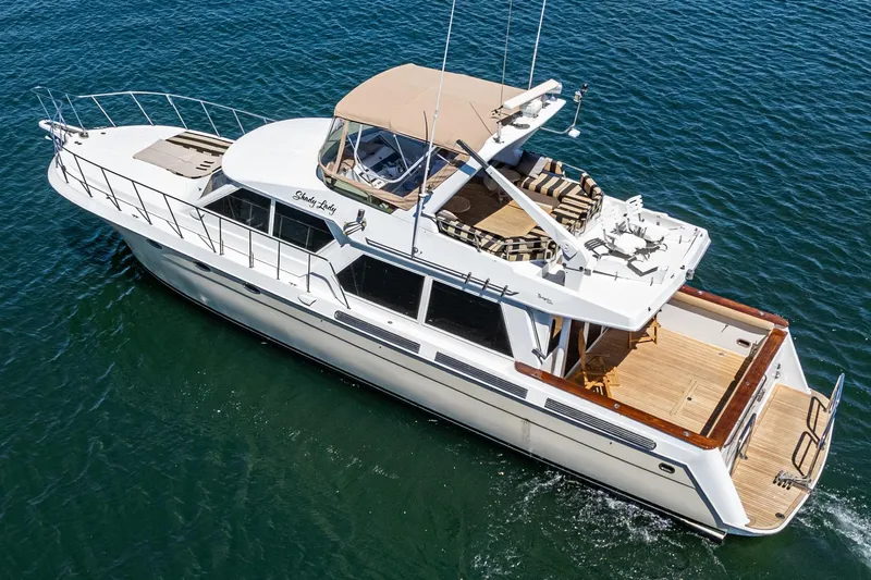Shady Lady Yacht Photos Pics Navigator Classic 1995 yacht cruising on open water, featuring spacious deck and elegant design.