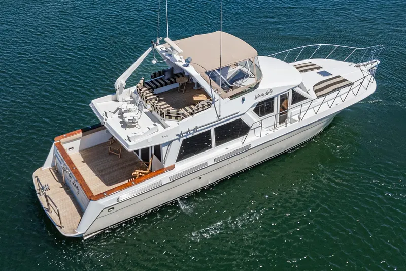 Shady Lady Yacht Photos Pics Luxurious 1995 Navigator Classic yacht cruising on clear blue waters.