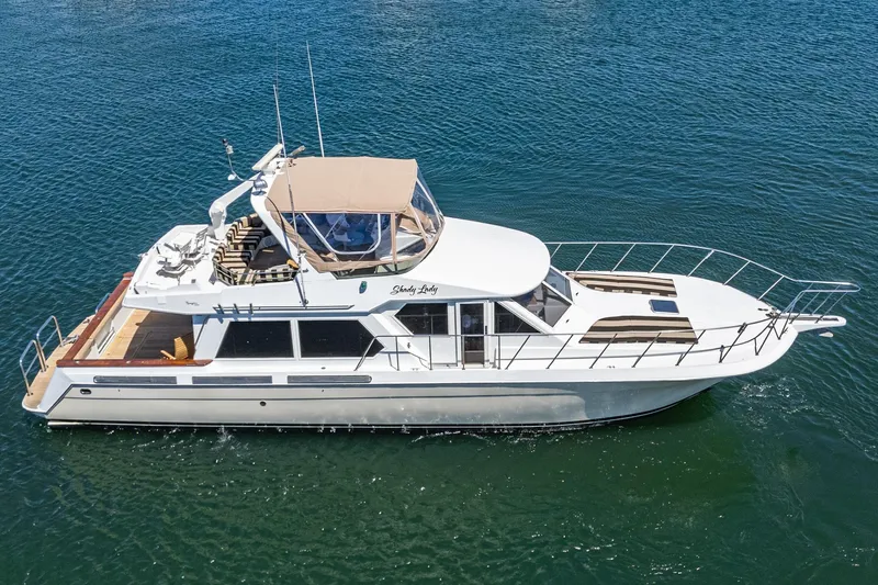 Shady Lady Yacht Photos Pics 1995 Navigator Classic yacht cruising on open water, featuring sleek design and spacious deck.