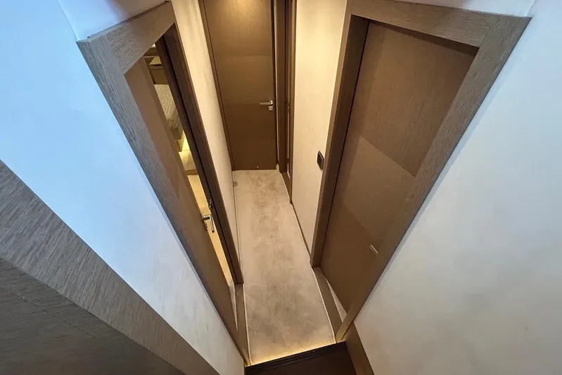  Yacht Photos Pics Narrow hallway with wooden doors inside a 2018 Prestige 680S yacht.