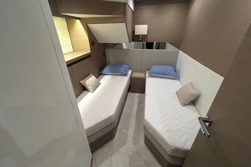  Yacht Photos Pics Twin cabin interior of 2018 Prestige 680S yacht with modern decor and cozy bedding.