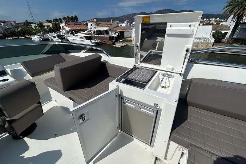  Yacht Photos Pics Luxury 2018 Prestige 680S yacht deck with seating and outdoor kitchenette.