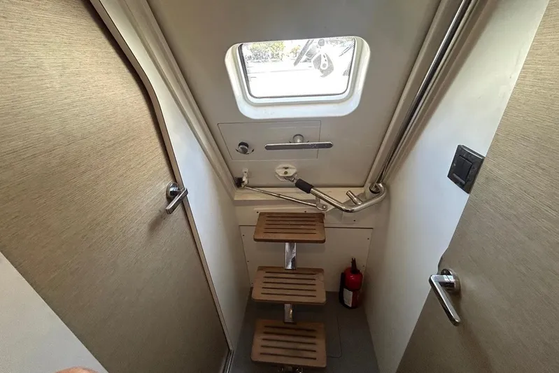  Yacht Photos Pics Interior of 2018 Prestige 680S yacht with wooden steps and window.