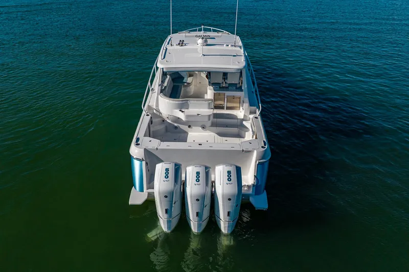 Karey Lee Yacht Photos Pics 2024 Intrepid 477 Evolution boat with triple 600 V12 engines on calm water.