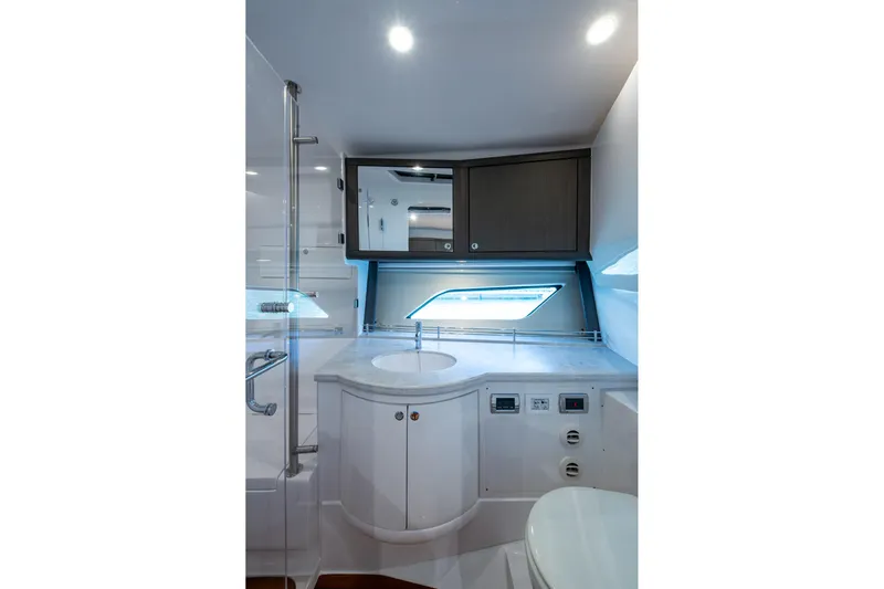Karey Lee Yacht Photos Pics Luxurious bathroom interior of 2024 Intrepid 477 Evolution yacht with modern fixtures.