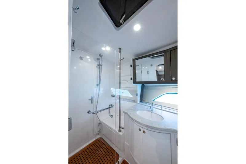 Karey Lee Yacht Photos Pics Luxurious bathroom in 2024 Intrepid 477 Evolution yacht with modern fixtures and elegant design.