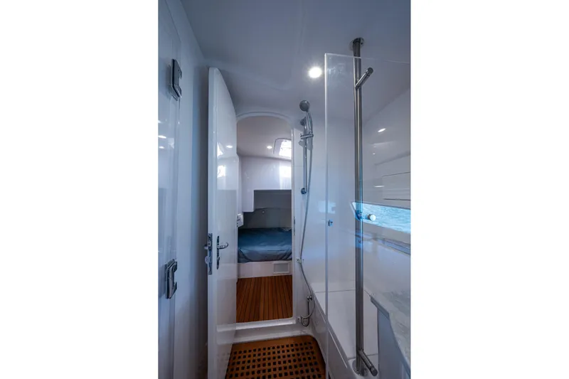 Karey Lee Yacht Photos Pics Luxurious interior of 2024 Intrepid 477 Evolution yacht, featuring sleek shower and cozy cabin.