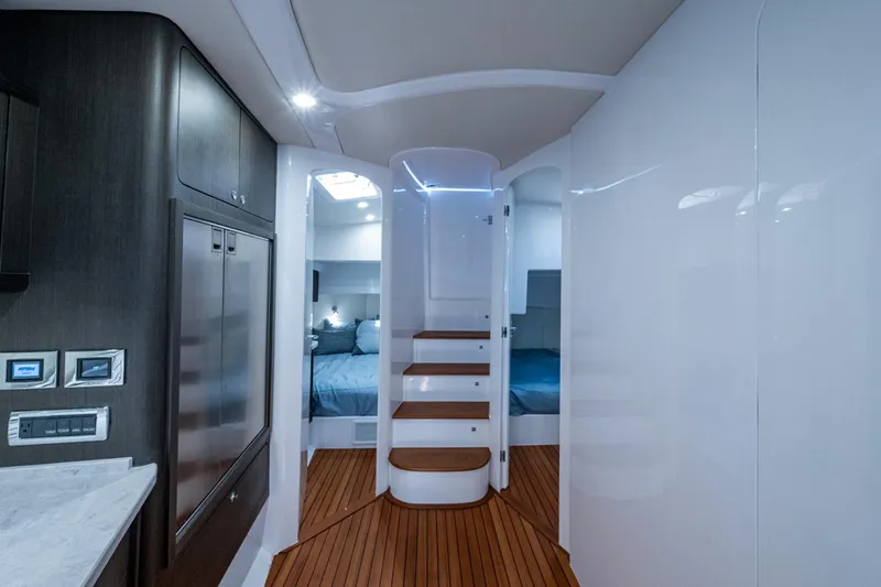 Karey Lee Yacht Photos Pics Luxurious interior of 2024 Intrepid 477 Evolution yacht with modern design and wooden flooring.