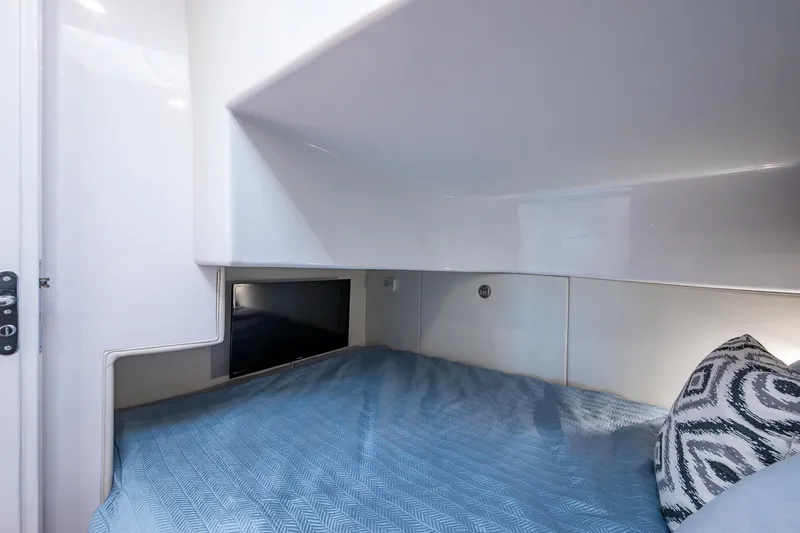 Karey Lee Yacht Photos Pics 2024 Intrepid 477 Evolution cabin interior with bed, pillow, and sleek design.