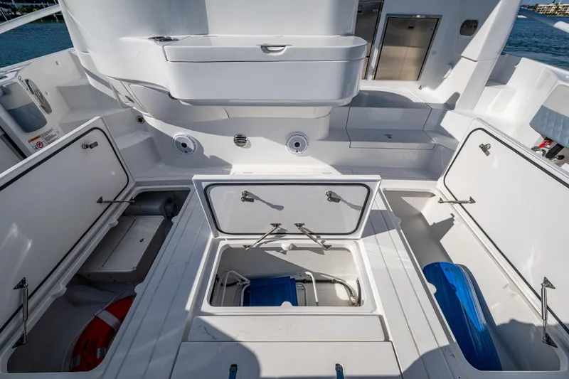 Karey Lee Yacht Photos Pics 2024 Intrepid 477 Evolution boat interior with open storage compartments.