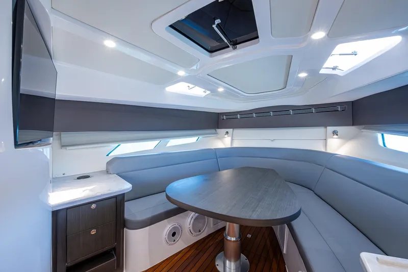 Karey Lee Yacht Photos Pics Luxurious interior of 2024 Intrepid 477 Evolution yacht with sleek seating and modern design.