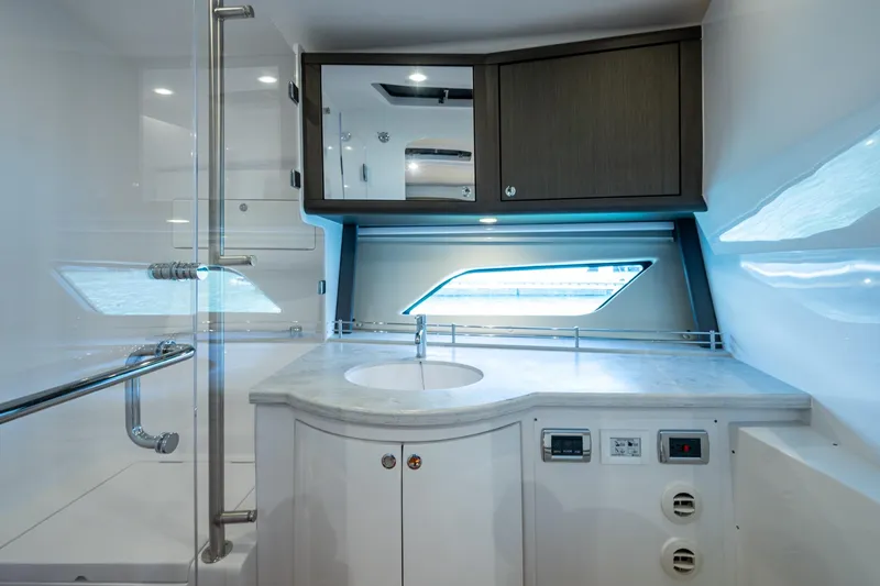 Karey Lee Yacht Photos Pics Luxurious bathroom interior of 2024 Intrepid 477 Evolution yacht with modern fixtures.