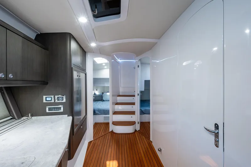 Karey Lee Yacht Photos Pics Luxurious interior of 2024 Intrepid 477 Evolution yacht with modern design and wood flooring.
