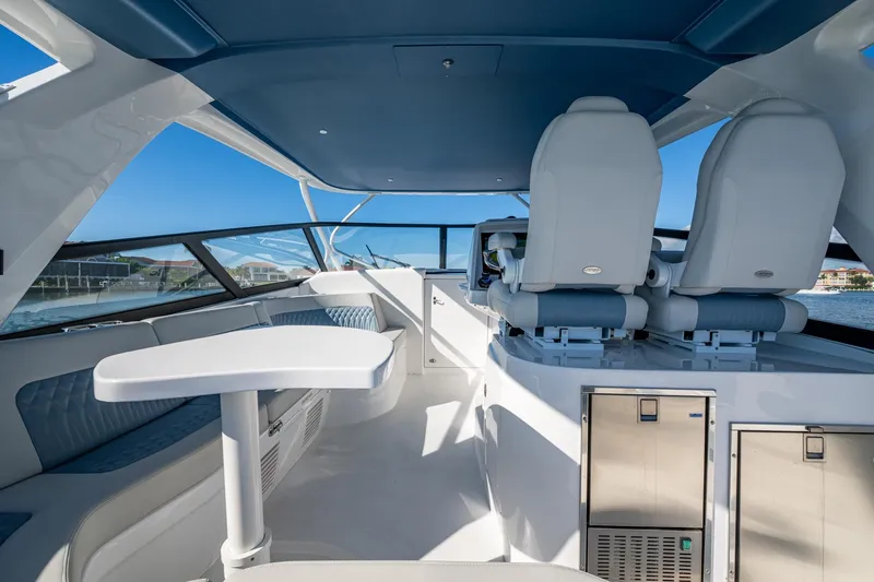 Karey Lee Yacht Photos Pics Luxurious interior of 2024 Intrepid 477 Evolution yacht with modern seating and sleek design.
