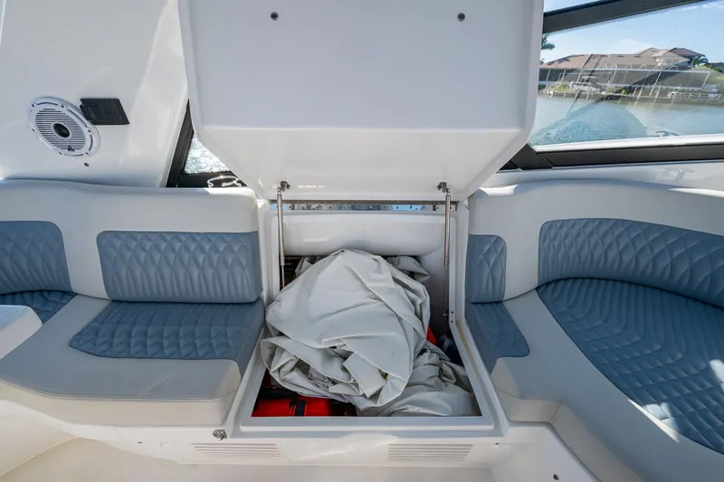 Karey Lee Yacht Photos Pics 2024 Intrepid 477 Evolution boat interior with open storage compartment and cushioned seating.