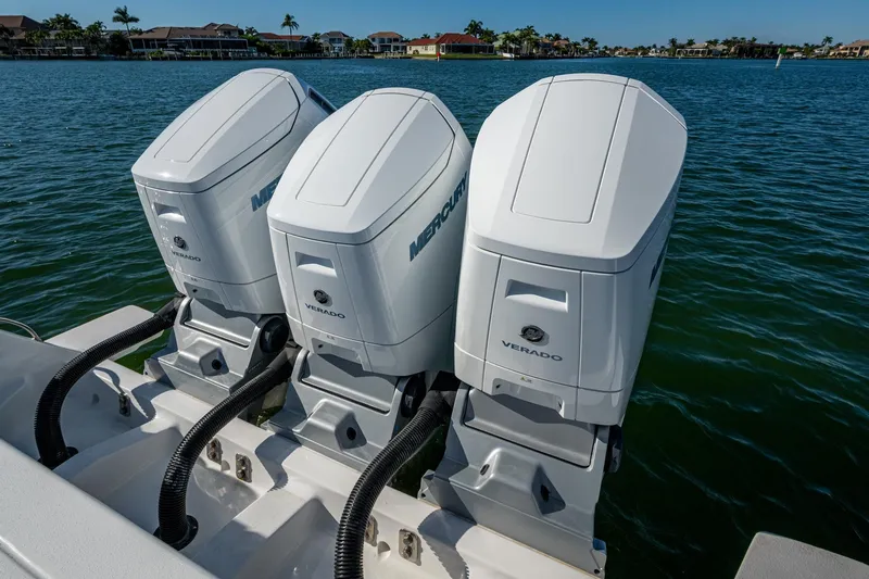 Karey Lee Yacht Photos Pics Triple Mercury Verado engines on 2024 Intrepid 477 Evolution boat, docked on calm water.