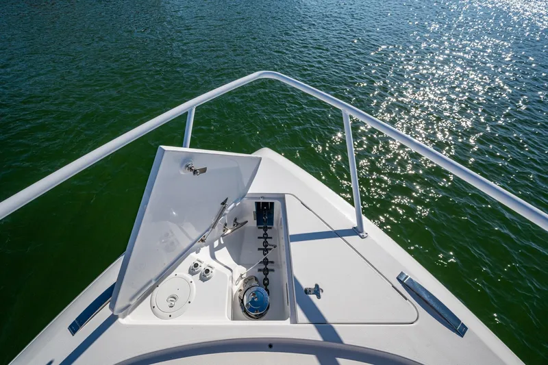 Karey Lee Yacht Photos Pics Bow view of 2024 Intrepid 477 Evolution yacht on sparkling water.