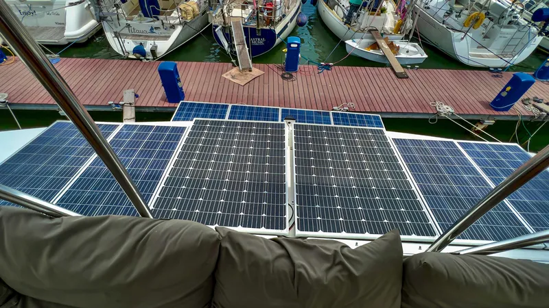 Octopus Yacht Photos Pics Solar panels on a 2017 Fountaine Pajot Ipanema 58 Power Catamaran docked at a marina.