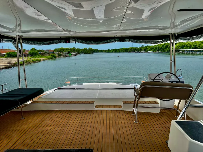 Octopus Yacht Photos Pics 2017 Fountaine Pajot Ipanema 58 Power Catamaran, rear deck view over serene waters.