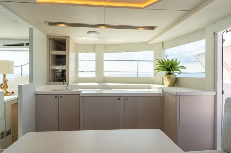  Yacht Photos Pics Luxurious yacht interior with modern kitchen, featuring sleek cabinets and ocean views. Two Oceans 555 - 008, 2025.