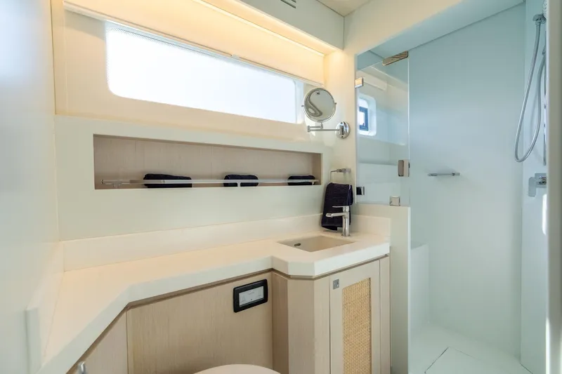  Yacht Photos Pics Modern yacht bathroom with sleek design, featuring a shower and vanity. Two Oceans 555 - 008, 2025 model.
