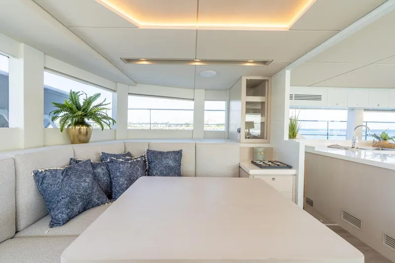  Yacht Photos Pics Luxurious yacht interior with modern dining area, plush cushions, and elegant decor. Two Oceans 555 - 008, 2025.