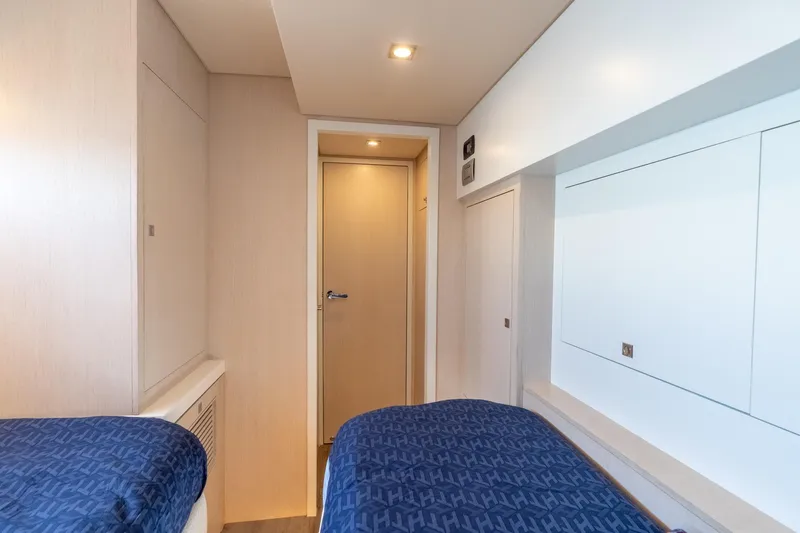  Yacht Photos Pics Modern yacht cabin interior with twin beds, sleek design, and ambient lighting, Two Oceans 555 - 008, 2025.