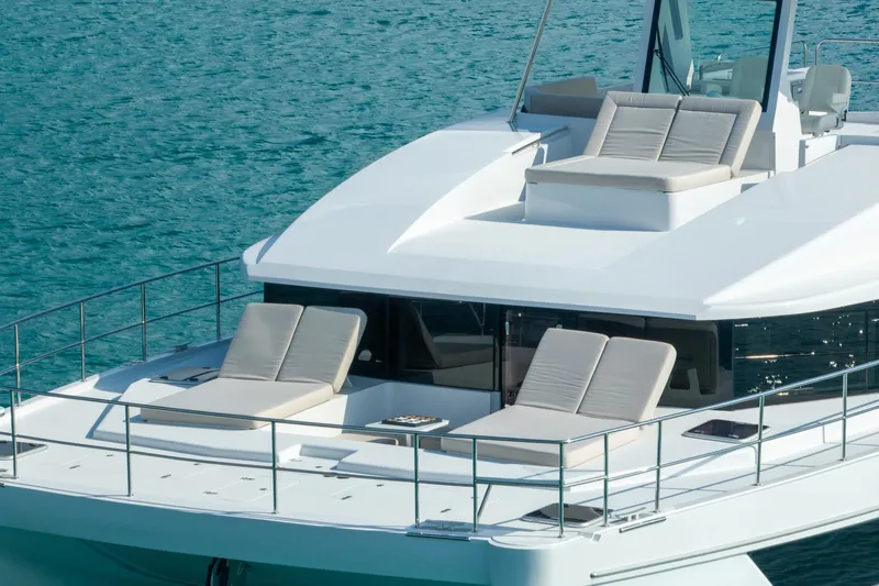  Yacht Photos Pics Luxurious 2025 Two Oceans 555 - 008 yacht with sun loungers on turquoise water.
