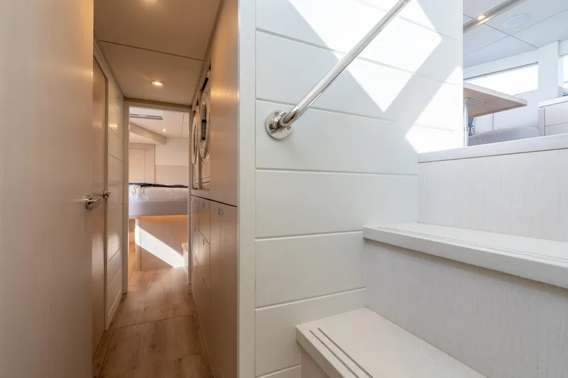  Yacht Photos Pics Modern yacht interior with wooden flooring, stairs, and a cozy bedroom. Two Oceans 555 - 008, 2025.