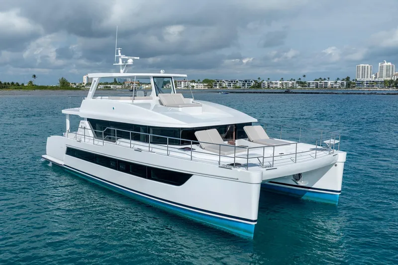  Yacht Photos Pics Luxury Two Oceans 555 - 008 catamaran yacht cruising in clear blue waters, 2025 model.