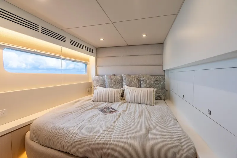  Yacht Photos Pics Luxurious yacht bedroom interior with modern design, featuring a large bed and ocean view window.
