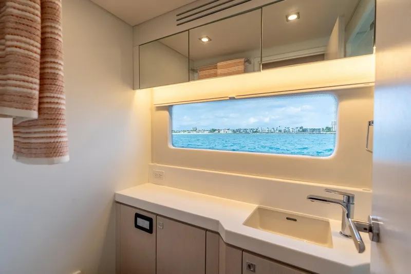  Yacht Photos Pics Modern yacht bathroom with ocean view, featuring sleek design and contemporary fixtures.