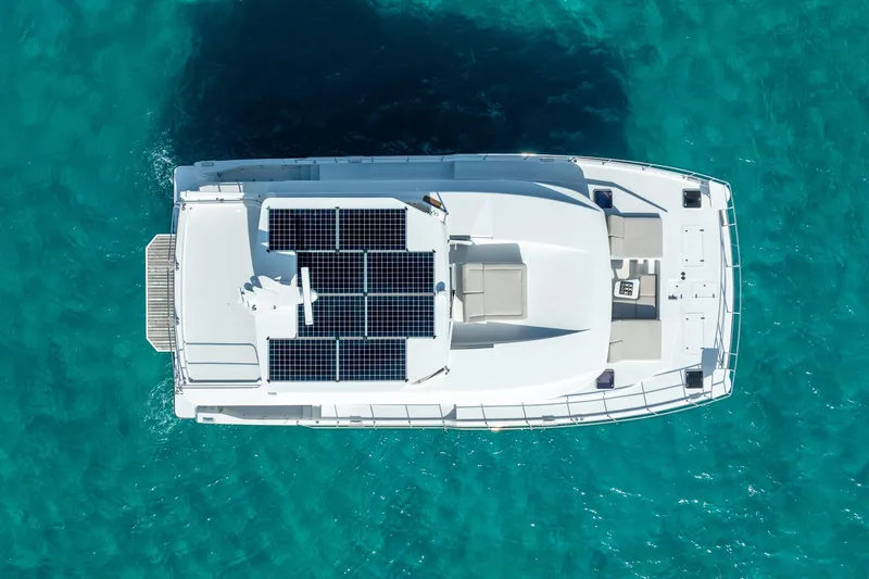  Yacht Photos Pics Aerial view of Two Oceans 555 - 008 yacht with solar panels, 2025 model, on turquoise water.