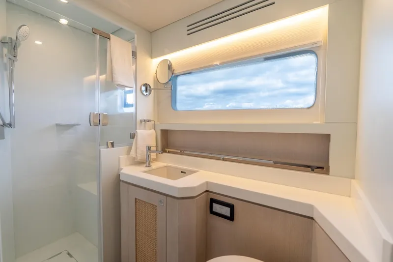  Yacht Photos Pics Luxurious yacht bathroom with modern fixtures, large window, and sleek shower in Two Oceans 555 - 008.