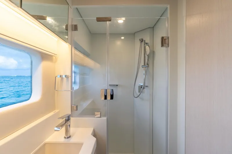  Yacht Photos Pics Modern yacht bathroom with ocean view, featuring sleek shower and sink. Two Oceans 555 - 008, 2025.