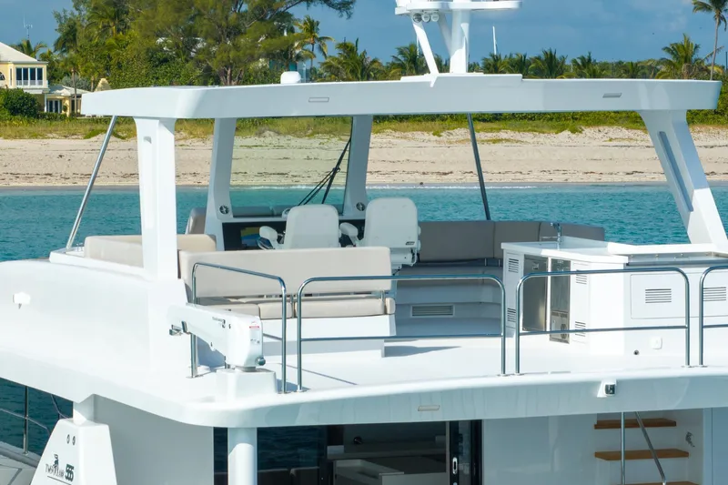  Yacht Photos Pics Luxurious 2025 Two Oceans 555-008 yacht with spacious deck, near tropical shoreline.