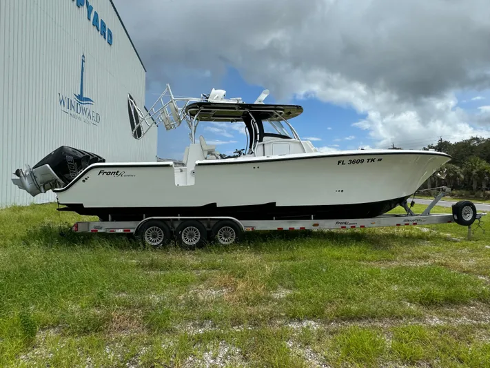  Yacht Photos Pics 2023 Front Runner 36 Center Console boat on trailer near a boatyard.