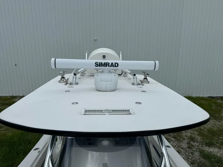 Yacht Photos Pics 2023 Front Runner 36 Center Console with Simrad radar, docked near a white building.