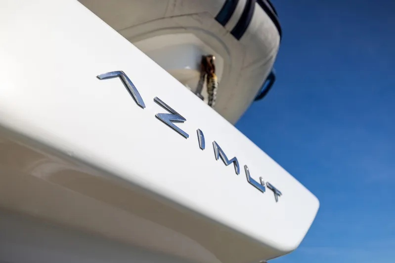 Freedom Yacht Photos Pics Azimut 68 yacht, 2005 model, close-up of logo against clear blue sky.