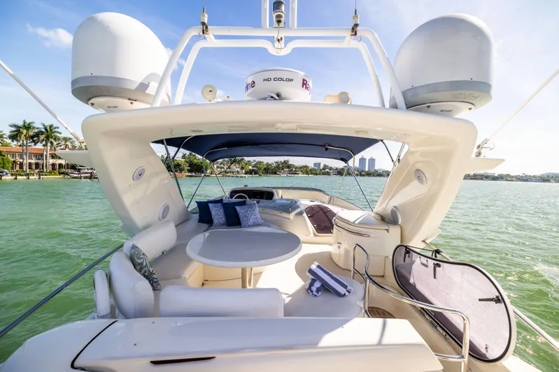 Freedom Yacht Photos Pics Luxurious 2005 Azimut 68 yacht with spacious deck and seating, cruising on serene waters.