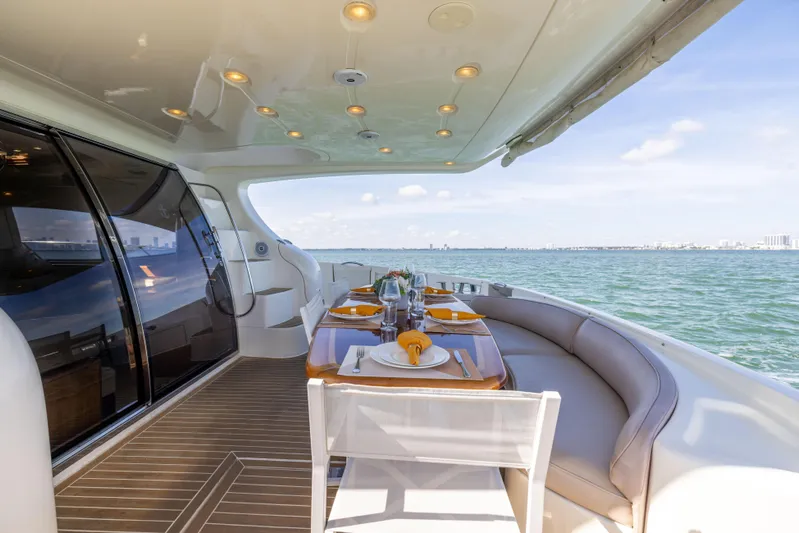 Freedom Yacht Photos Pics Luxurious dining area on a 2005 Azimut 68 yacht with ocean view.