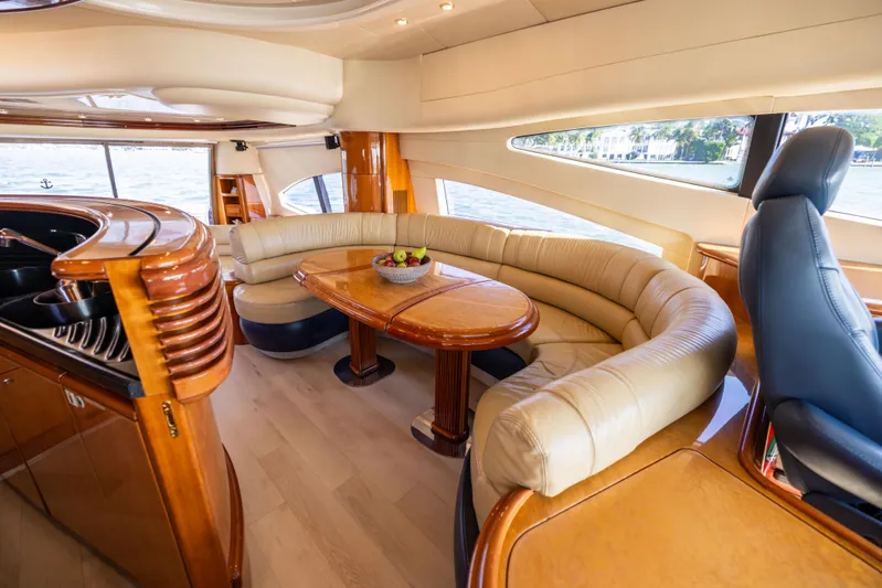 Freedom Yacht Photos Pics Luxurious interior of 2005 Azimut 68 yacht with elegant seating and wooden table.
