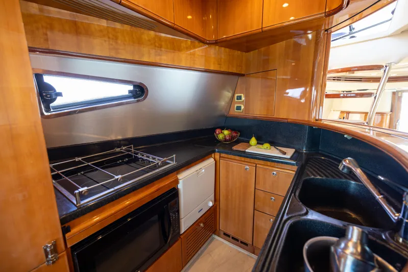 Freedom Yacht Photos Pics Luxurious kitchen interior of 2005 Azimut 68 yacht with modern amenities.