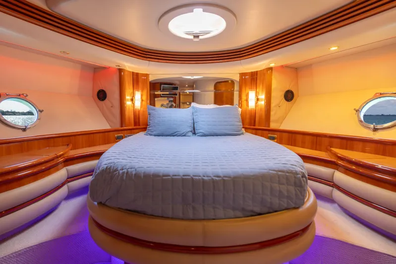 Freedom Yacht Photos Pics Luxurious bedroom interior of 2005 Azimut 68 yacht with circular bed and ambient lighting.