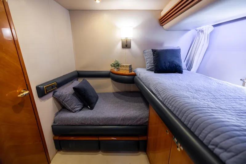 Freedom Yacht Photos Pics Luxurious cabin interior of 2005 Azimut 68 yacht with cozy bedding and elegant decor.