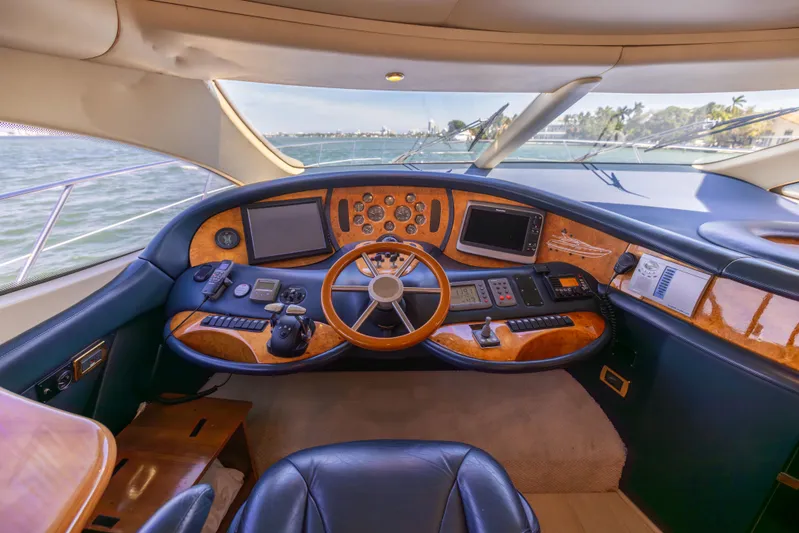 Freedom Yacht Photos Pics Luxurious 2005 Azimut 68 yacht helm with wood accents and modern navigation equipment.